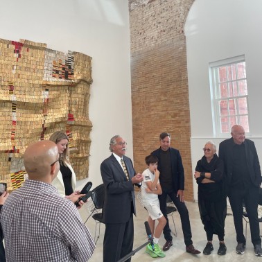 BBB Partner Hany Hassan addressing press next to the Rubell family, in front of El Anatsui’s “Another Man’s Cloth”, 2006